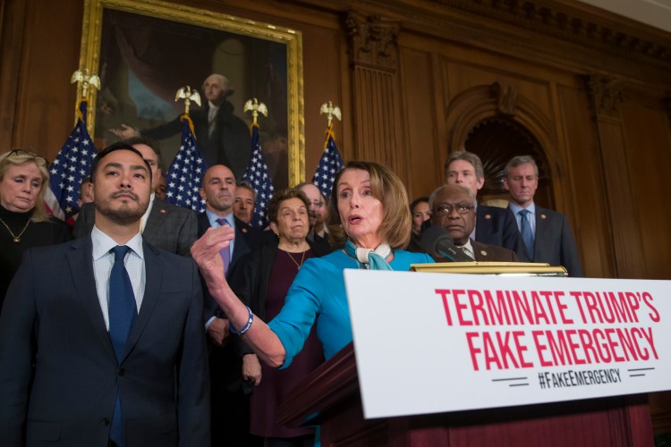 House Speaker Nancy Pelosi of California, accompanied by Rep. Joaquin Castro, D-Texas, left, and others, speaks about a resolution to block President Trump's emergency border security declaration on Capitol Hill on Monday in Washington. The House on Tuesday passed a resolution to block the declaration issued last week to fund his long-sought wall along the U.S-Mexico border, setting up a fight that could result in Trump's first-ever veto.