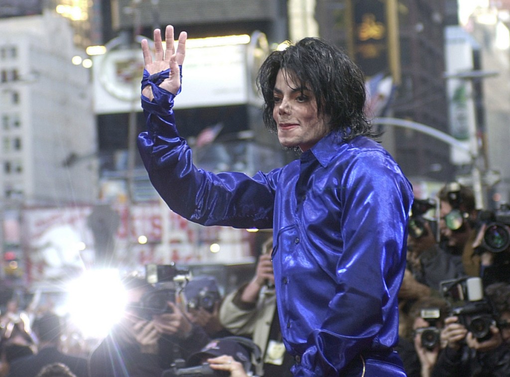 Michael Jackson waves to crowds gathered to see him at his first-ever in-store appearance in New York, on Nov. 7, 2001. The producers of "The Simpsons" are removing a classic episode that featured the voice of Jackson.