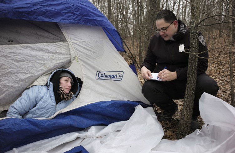 Police officer Angel Rivera asks a homeless woman, who identified herself only as Ashley, if she has been tested for Hepatitis A last month in Worcester.