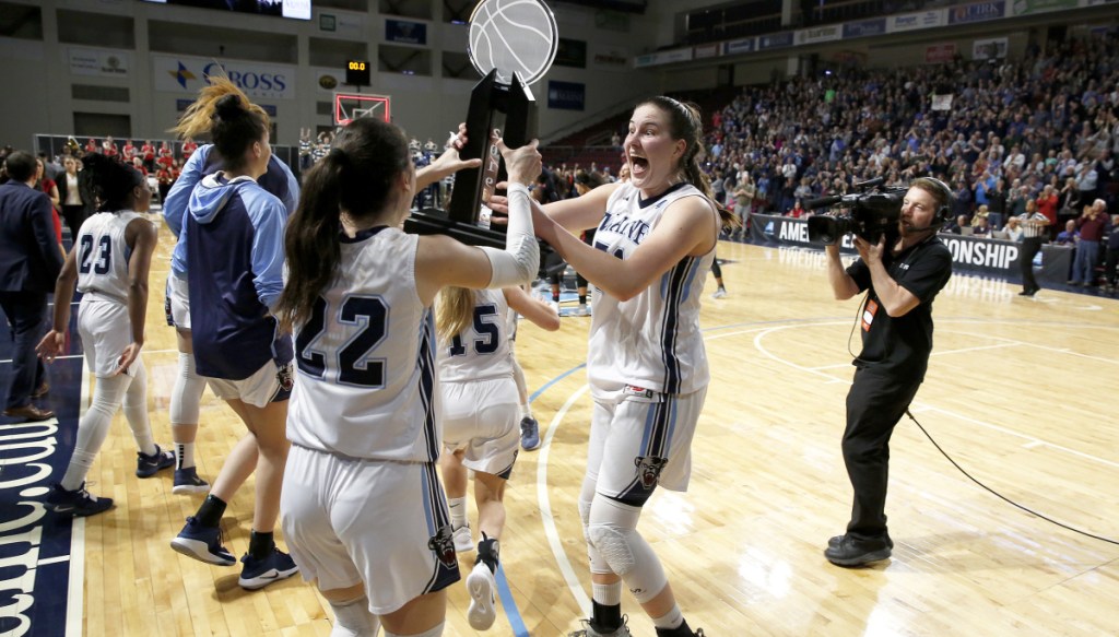 UMaine's Fanny Wadling, right, and Blanca Millan get their hands on the America East trophy after defeating Hartford on Friday in Bangor. More coverage, Page D1