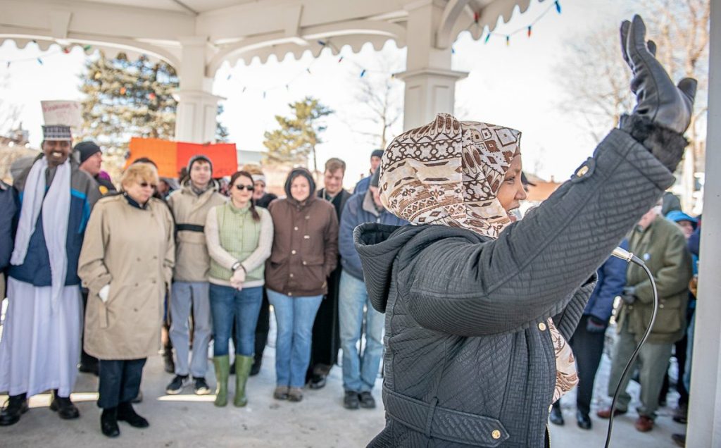 Fatuma Hussein waves to the crowd gathered at Kennedy Park at the start of the Standing Up Against Hate community vigil.