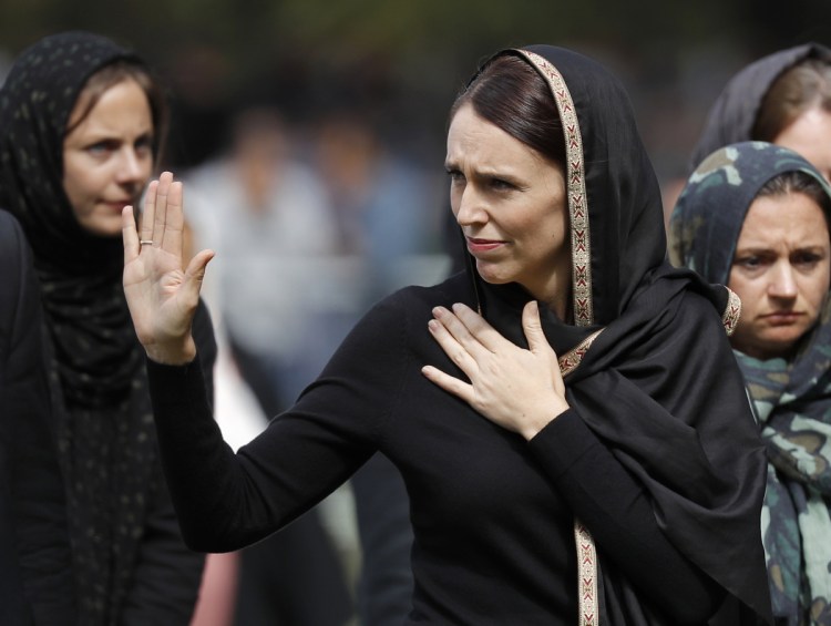 New Zealand Prime Minister Jacinda Ardern waves as she leaves Friday prayers at Hagley Park in Christchurch, New Zealand. People across New Zealand observed the Muslim call to prayer Friday as the nation reflected on the moment a week ago when 50 people were slaughtered at two mosques.