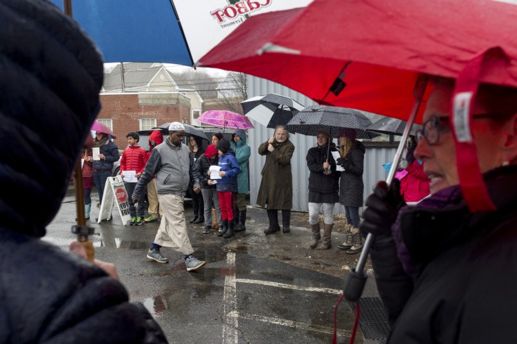 A man walks into the Maine Muslim Community Center for Friday afternoon prayers amid a group of Mainers standing in solidarity with the Muslim community outside of the mosque while they pray in response to the mass shooting in New Zealand.