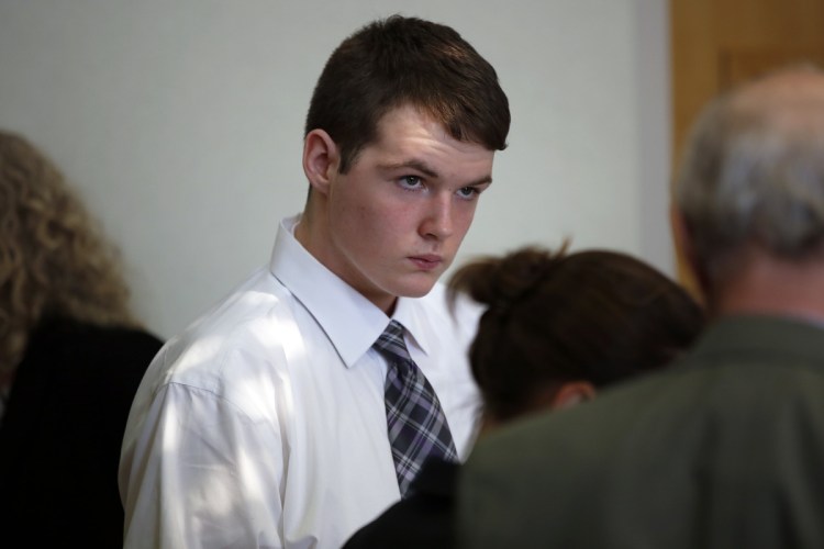 Dominic Sylvester confers with lawyers during a recess in his hearing on Thursday in West Bath District Court. The hearing will determine whether he will be tried as an adult. Sylvester was arrested and charged with murder in his grandmother's death when he was just 16 years old. 