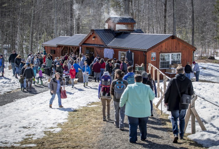 Visitors tour Dunn Family Farm in Buxton as part of Maine Maple Sunday. 