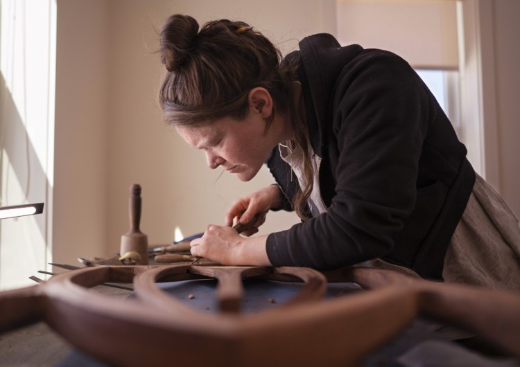 Aspen Golann, an artist and fine-furniture maker from Boston, works on a chair back in a studio at Monson Arts on Wednesday. Monson Arts recently partnered with the Rhode Island School of Design to offer two-month residencies to RISD graduates. The organization is funded by the Libra Foundation that seeks to help develop Piscataquis County, which has only 17,000 residents, but the highest poverty rate in the state.