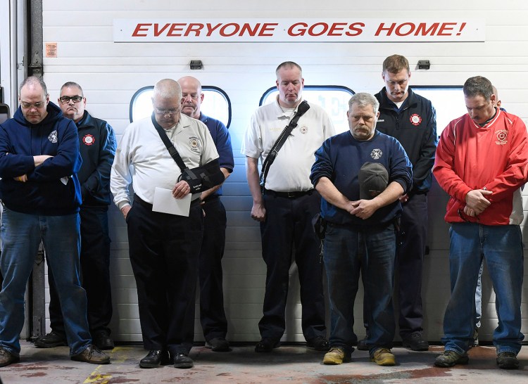 Firefighters from Berwick and surrounding communities participate in a moment of silence for Fire Capt. Joel Barnes, who died in last Friday's fire. 