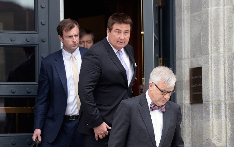 Michael Liberty, center, leaves the federal district courthouse in Portland on Thursday after pleading not guilty to defrauding investors of millions of dollars. With Liberty are his attorney's Alfred Frawley IV, left, and Thimi Mina.