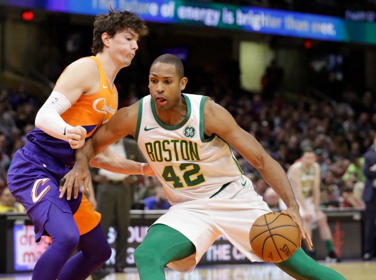 Boston's Al Horford drives past Cleveland's Cedi Osman during Tuesday's game in Cleveland. (Associated Press/Tony Dejak)