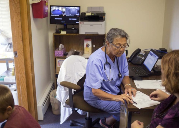 Priscilla Perry, a nurse practitioner with Maine Family Planning, consults with one of her patients at her Machias office in 2017. She applauds efforts to remove barriers to reproductive health services in rural Maine.