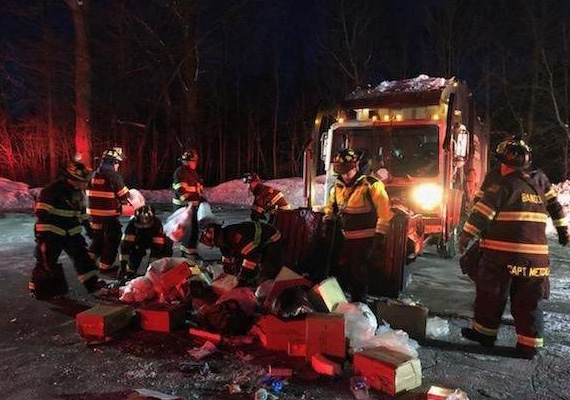 Bangor fire fighters clean up the scene where a man was found in a garbage truck Thursday evening. 