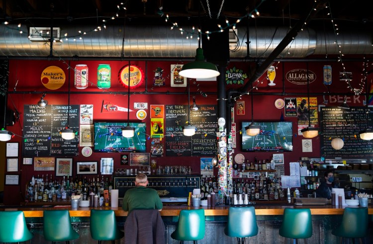 Craig Bodo of Raleigh, North Carolina, watches the Patriots play at Salvage BBQ in Portland. He said he wanted a place to watch the game while also enjoying good food and beer.