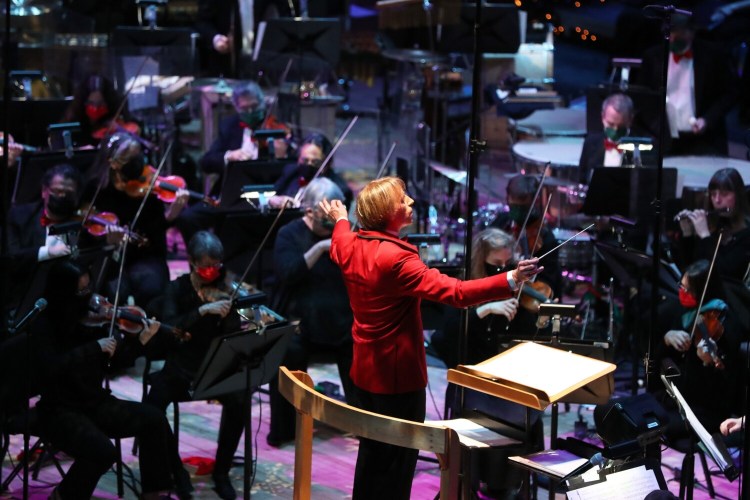 Eckart Preu, music director, conducts the Portland Symphony Orchestra in "Magic of Christmas," which opened its 42nd year with a live audience again at Merrill Auditorium on Friday afternoon.