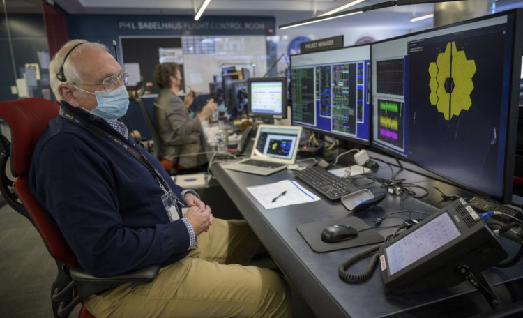 NASA James Webb Space Telescope Project Manager Bill Ochs monitors the progress of the observatory's second primary mirror wing as it rotates into position, Saturday, from NASA's James Webb Space Telescope Mission Operations Center at the Space Telescope Science Institute in Baltimore.