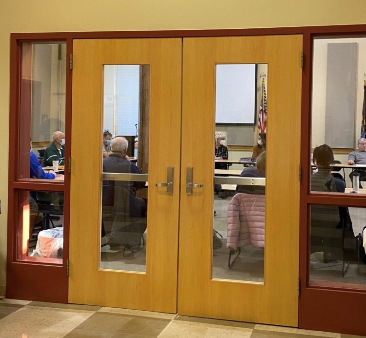 MSAD 17 Superintendent Monica Henson, at left through the righthand door to the school board rood in Paris, talks Wednesday with board Chairwoman Natalie Andrews before an executive session. Henson was placed on paid administrative leave during the closed session after allegations she inappropriately physically restrained a student at Agnes Gray Elementary School in West Paris.