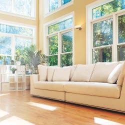 Sectional sofa in a large luxury interior home, with huge windows, light pouring in