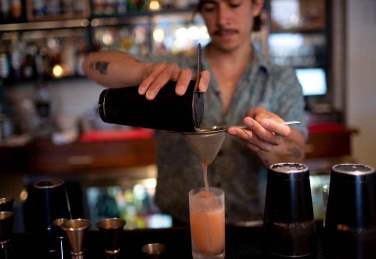 Magnus on Water co-owner Brian Catapang mixes a Rubix Cube cocktail. 