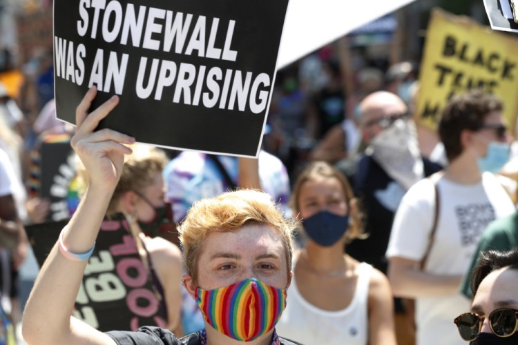 A person holds up a sign during a queer liberation march for Black Lives Matter and against police brutality in June 2020 in New York.