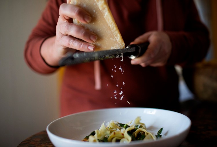 To finish, grate Parmesan cheese over the lemon-asparagus pansoti.