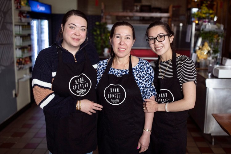 From left, Tuyet Thi Le, who also goes by the English translation of her name, "Snow," Huong Le and Trinh Le-Tran pose for a photo together at Snow Thi Le’s takeout restaurant, Banh Appetit. The two girls grew up in their mother Huong Le’s restaurant, Huong, on St. John’s Street, that she has since sold. 